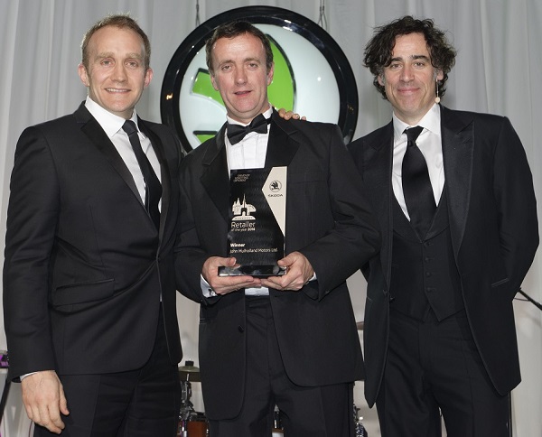 John collecting the trophy from Duncan Movassaghi left (Director ŠKODA UK) along with actor Stephen Mangan right.