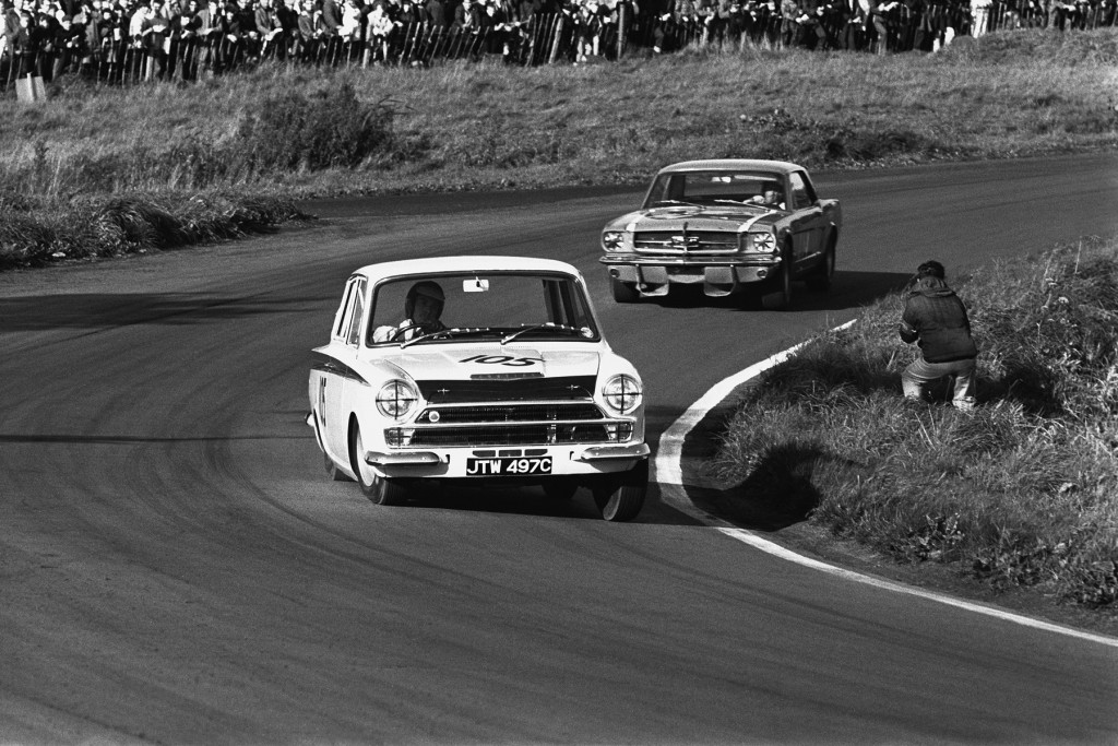 1965 British Saloon Car Championship. Oulton Park, Cheshire, England. 18th September 1965. Rd  8. Jim Clark (Lotus Ford Cortina), 2nd position, leads Jack Brabham (Ford Mustang), 1st position, action.  World Copyright: LAT Photographic. Ref:  L65 - 488-30A.