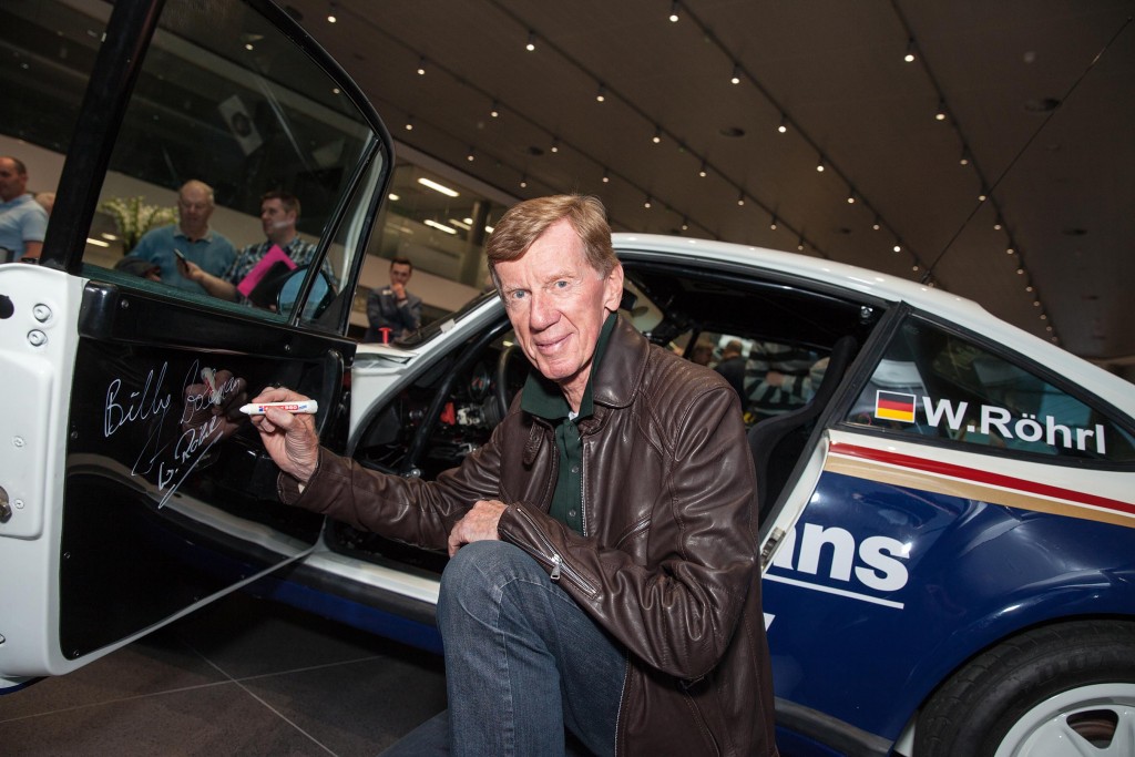 Rallying Legend Walter Rohrl signing the door card of the Porsche he will drive tomorrow...